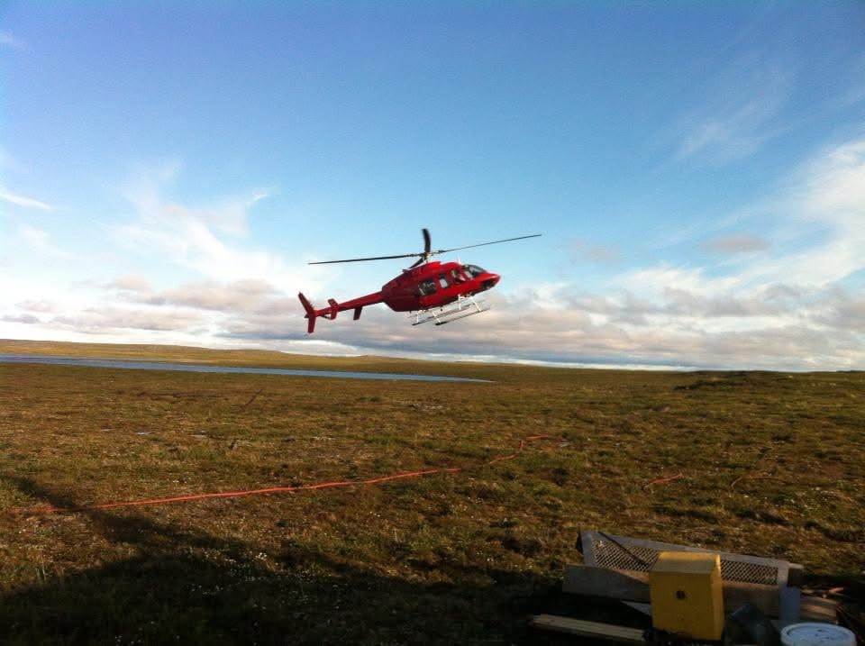 Diamond drilling rig working in a rugged field setting